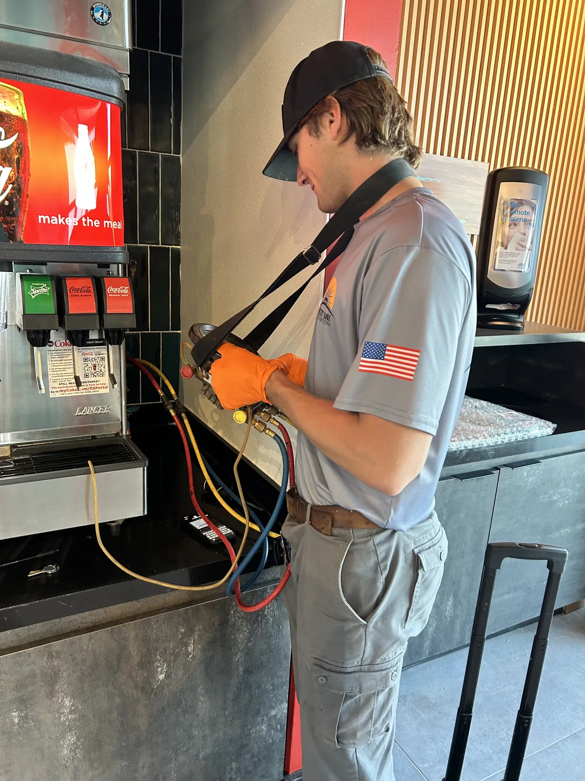 Uniformed Next Day Backflow Testing technician testing a restaurant soda fountain backflow assembly